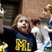 Natalie Harper slaps hands with Michigan fans after the softball game on Saturday, May 4. Daniel Brenner I AnnArbor.com